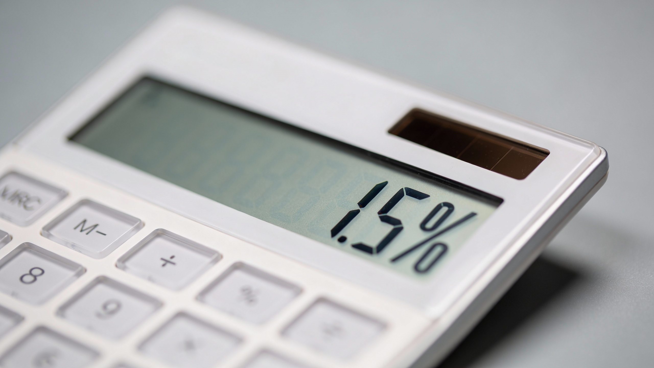 calculator display showing interest rate percentage, soft studio light