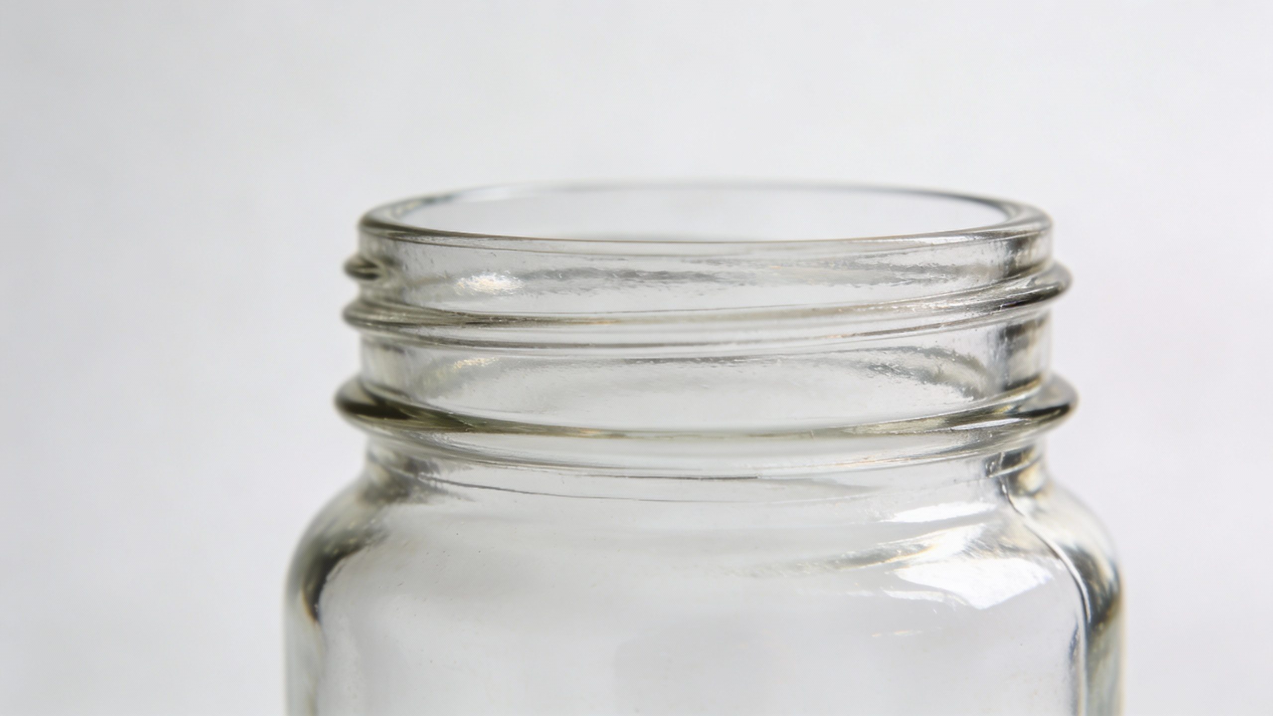 Closeup of a single glass savings jar labeled “Six-Month Break”