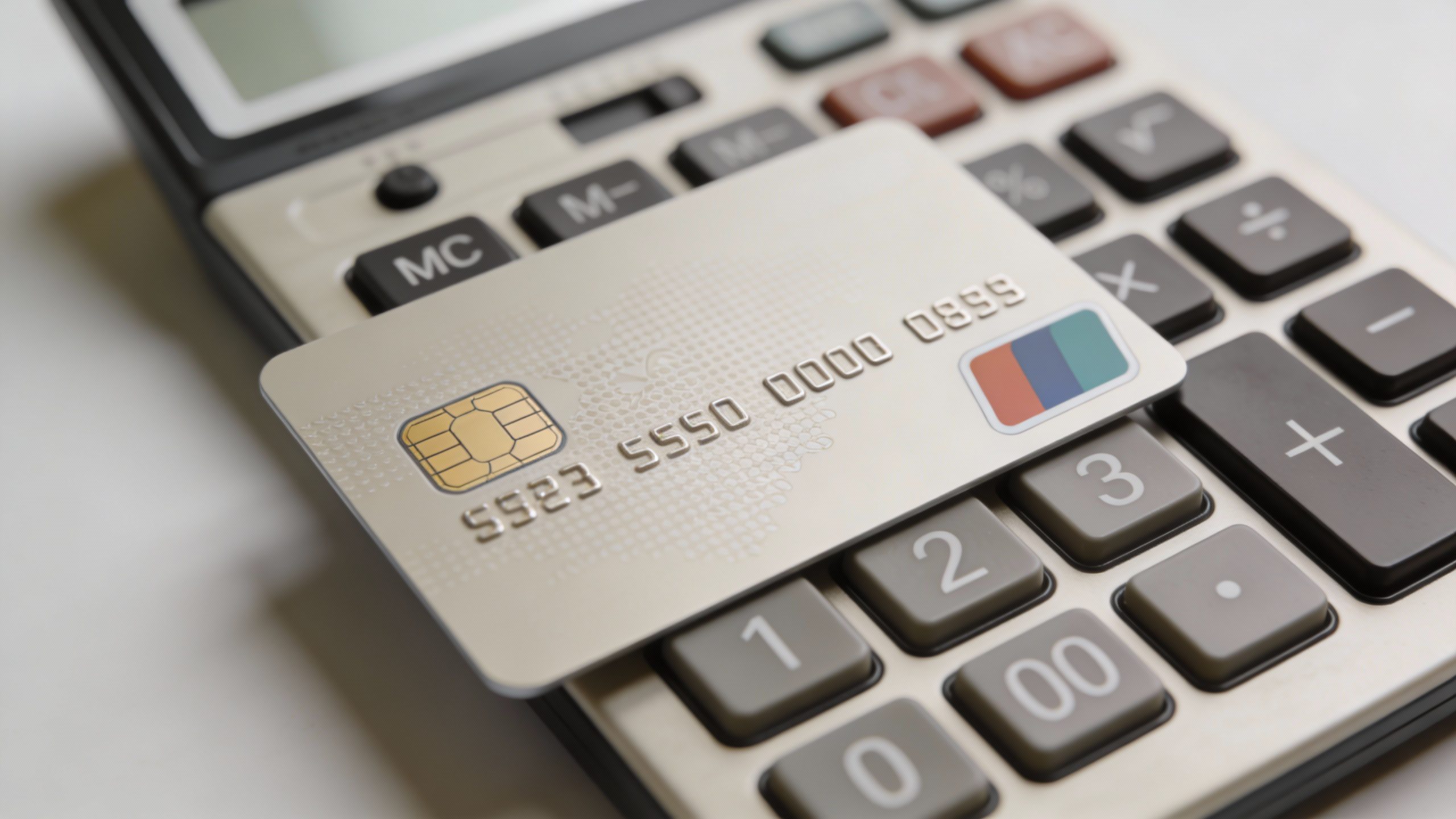 **Overhead shot of a debit card on a calculator**