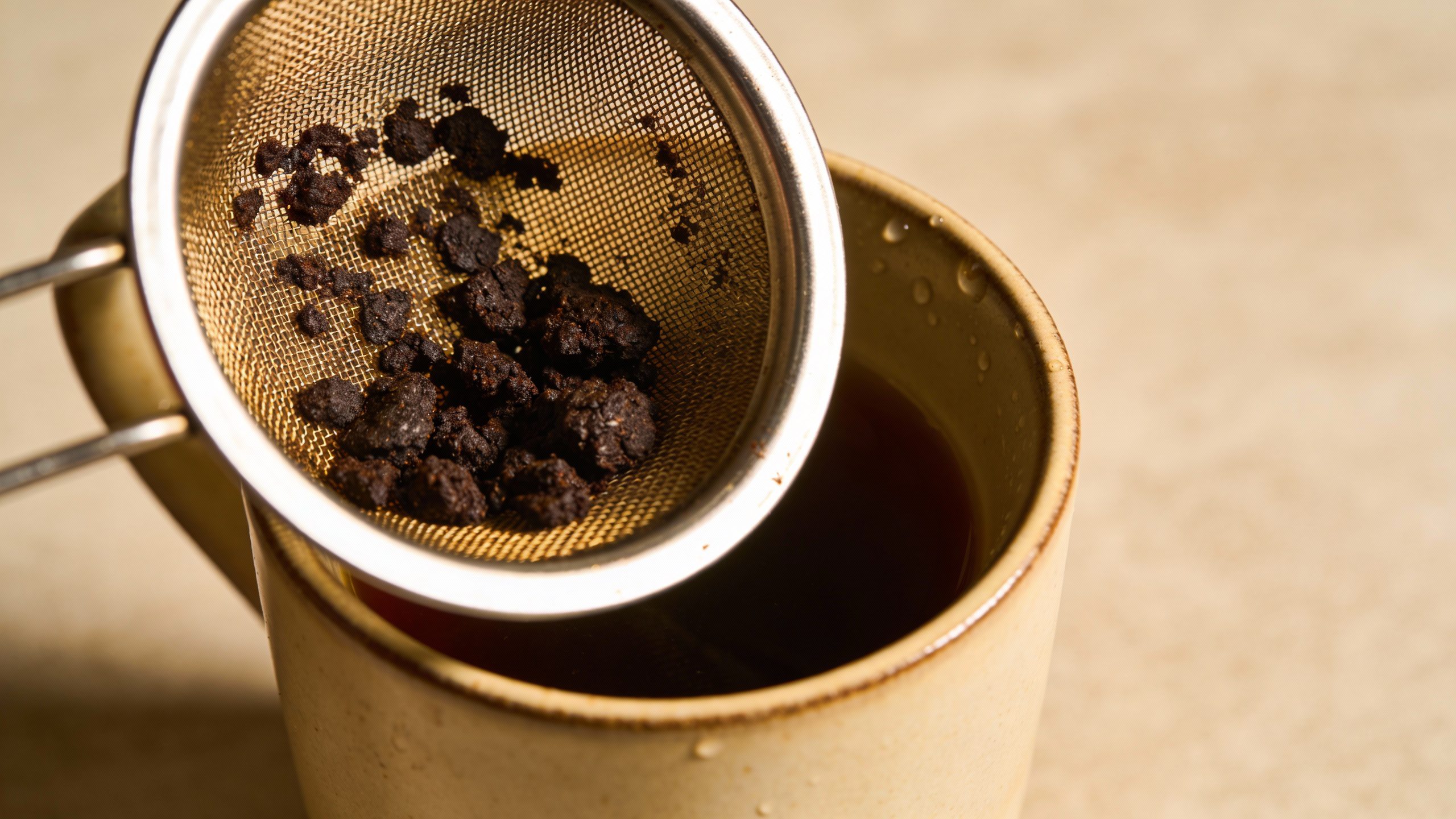 **Closeup of a coffee cup with a reusable filter and grounds**  Each prompt is focused, professional, and directly tied to the article’s key frugal living tips.