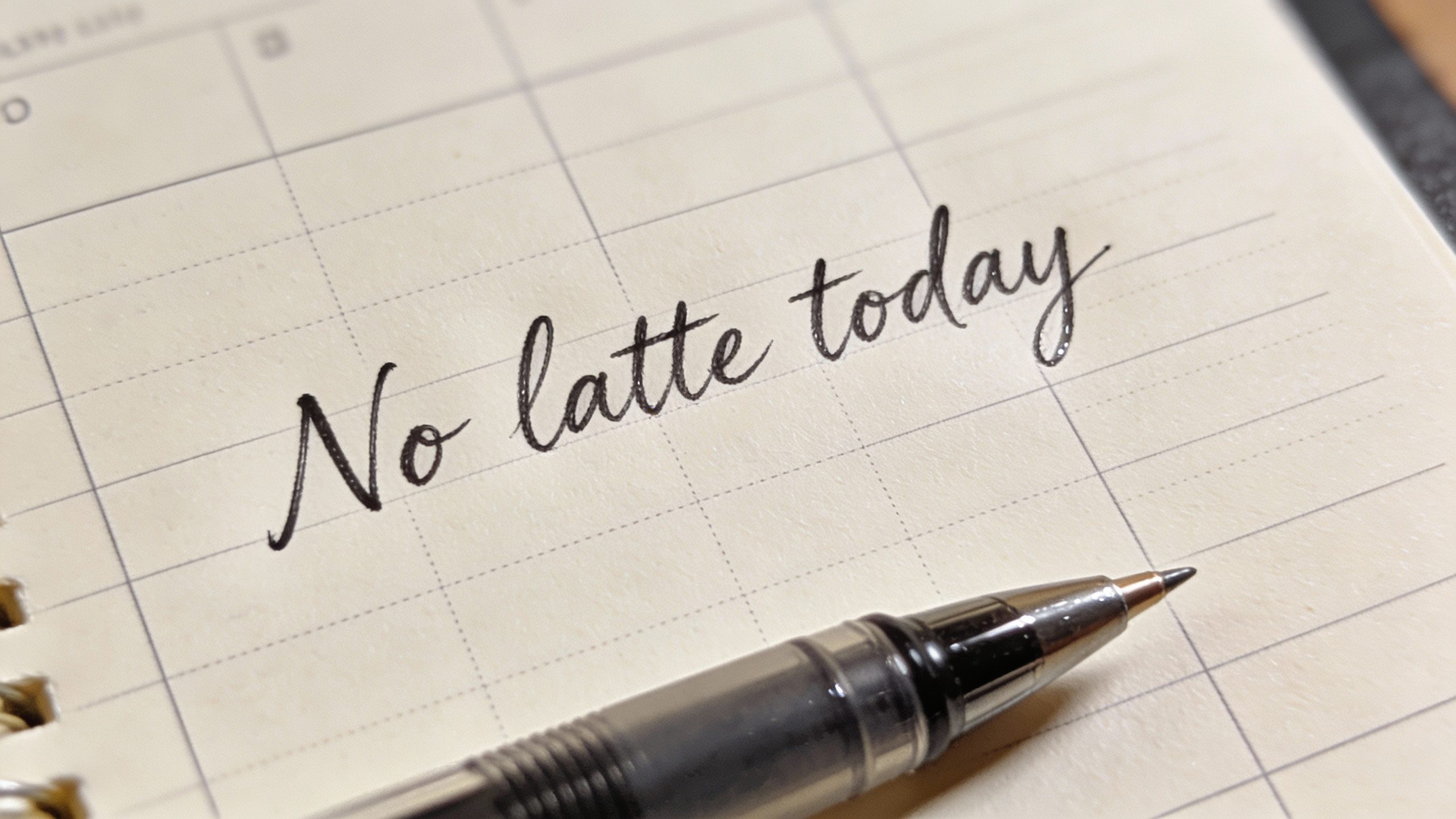 single gel pen writing “No latte today” in planner margin