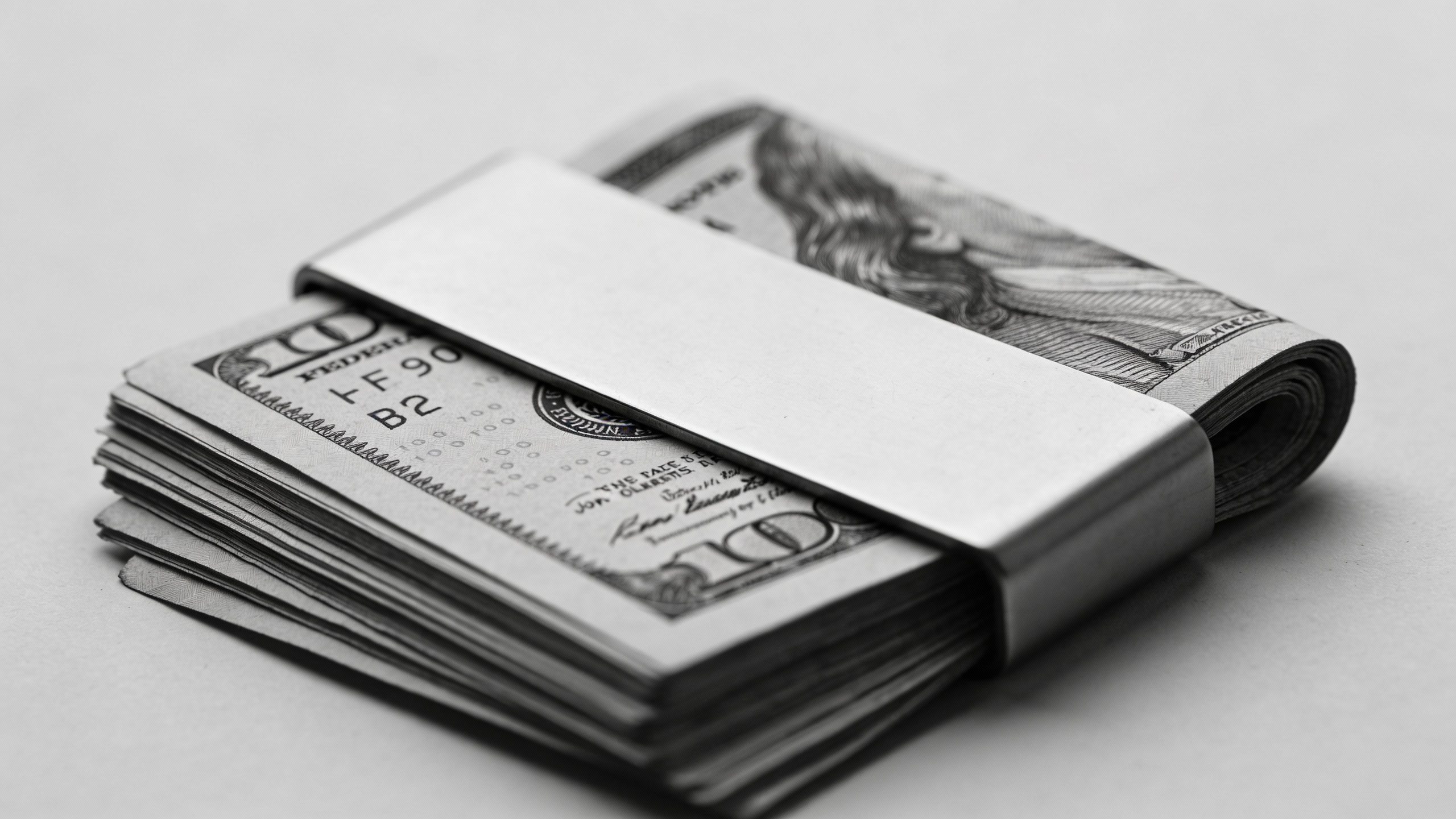 **Neat stack of cash in a monochrome money clip**