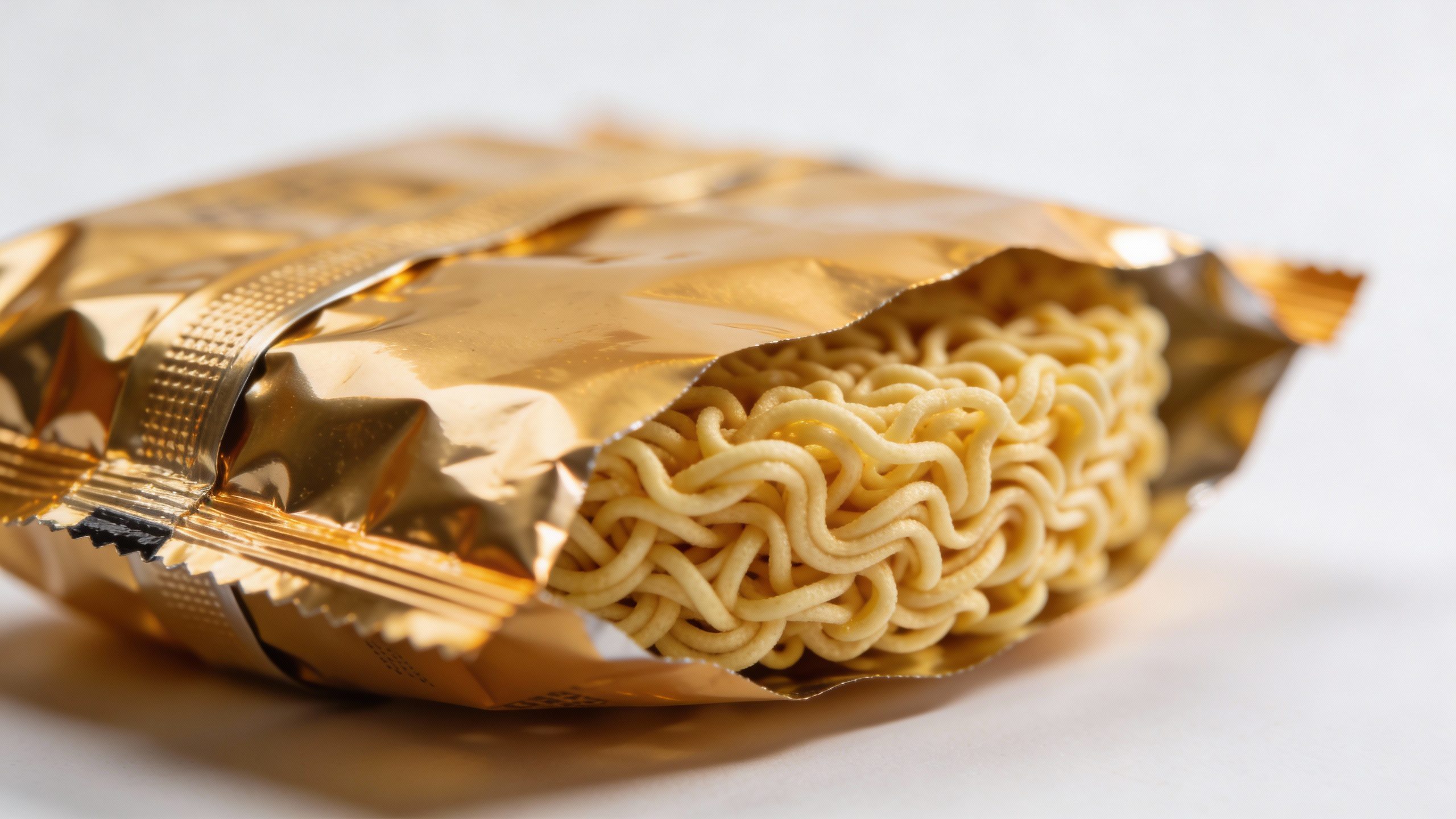 **Closeup of a ramen packet on a plain background**