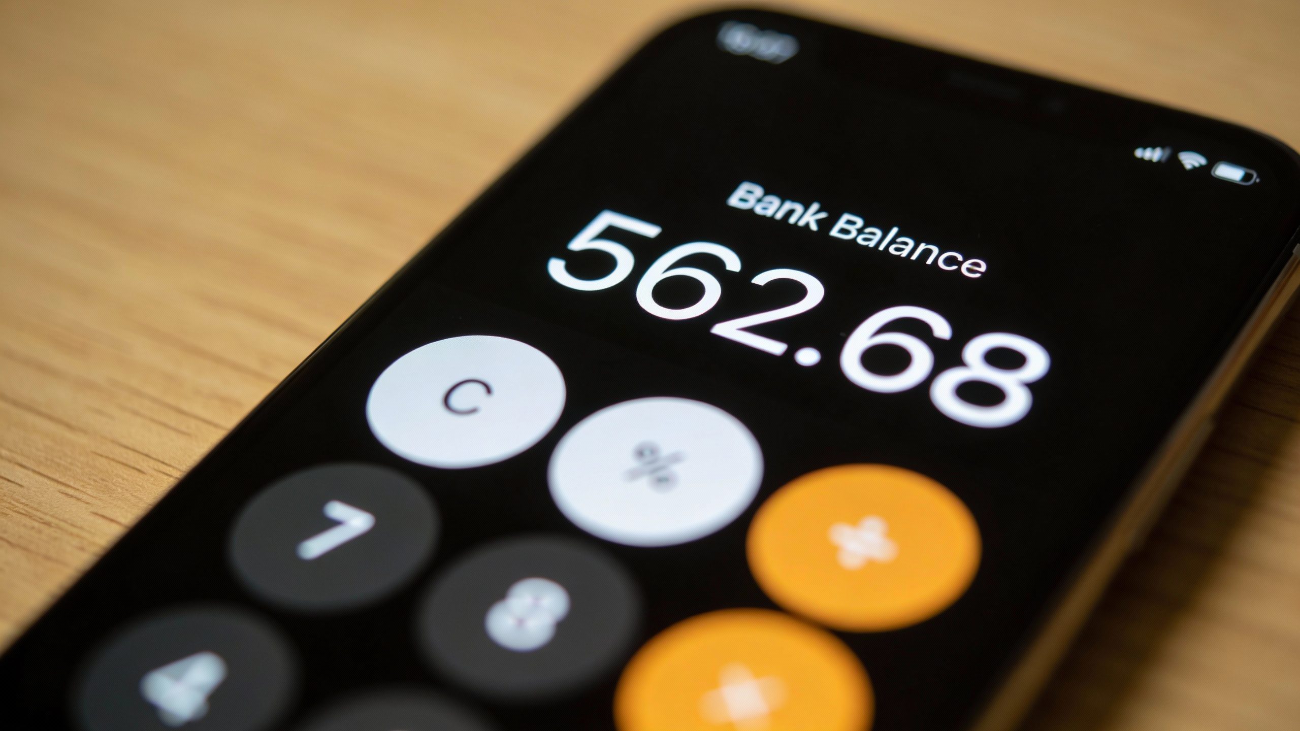 **Closeup of smartphone screen showing bank app balance**