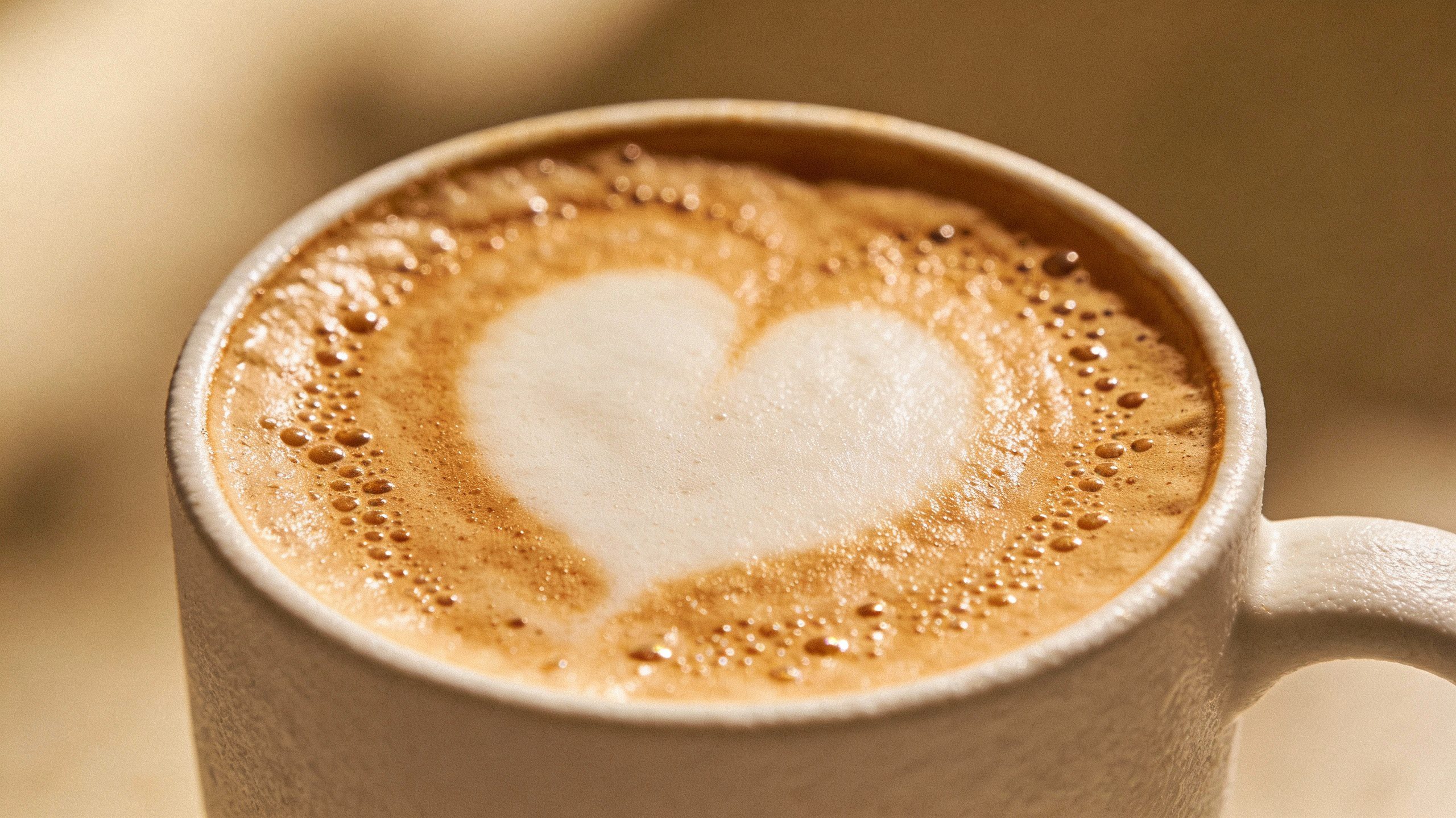 **Closeup of a frothy latte in a white mug**