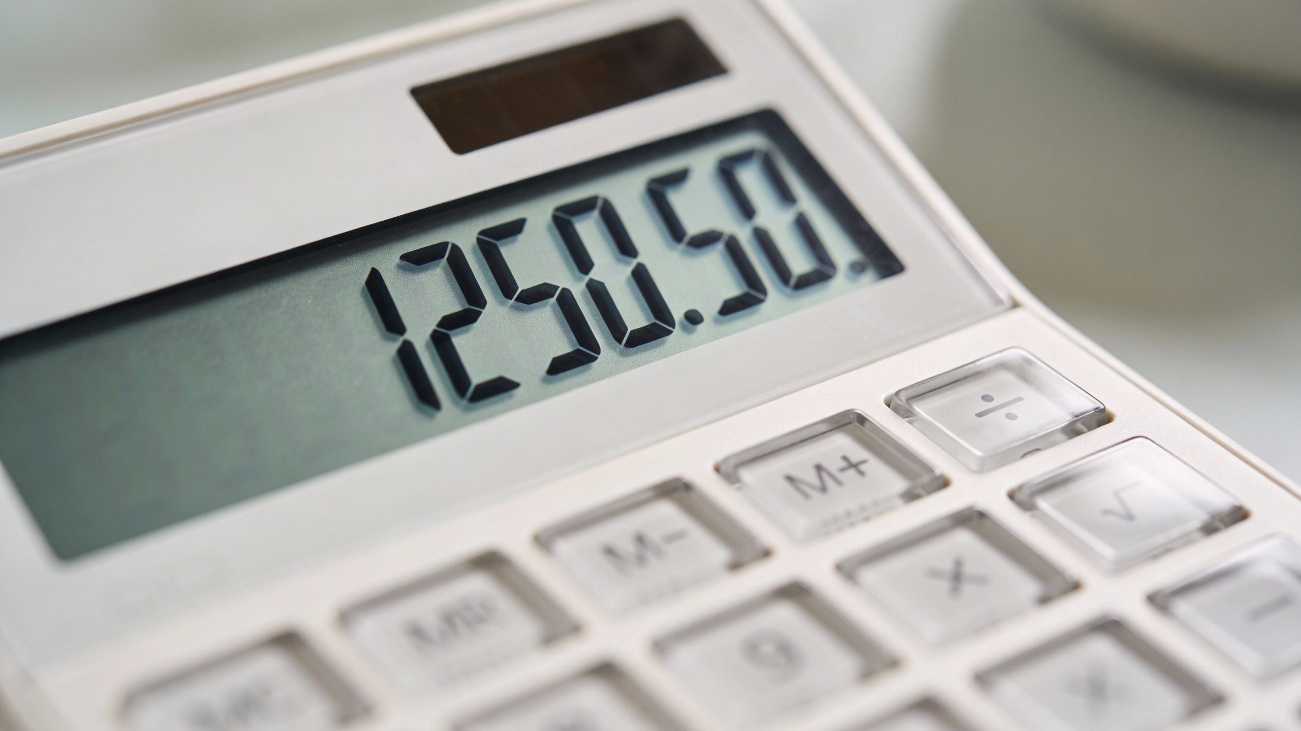 Closeup of a single calculator displaying monthly expenses total
