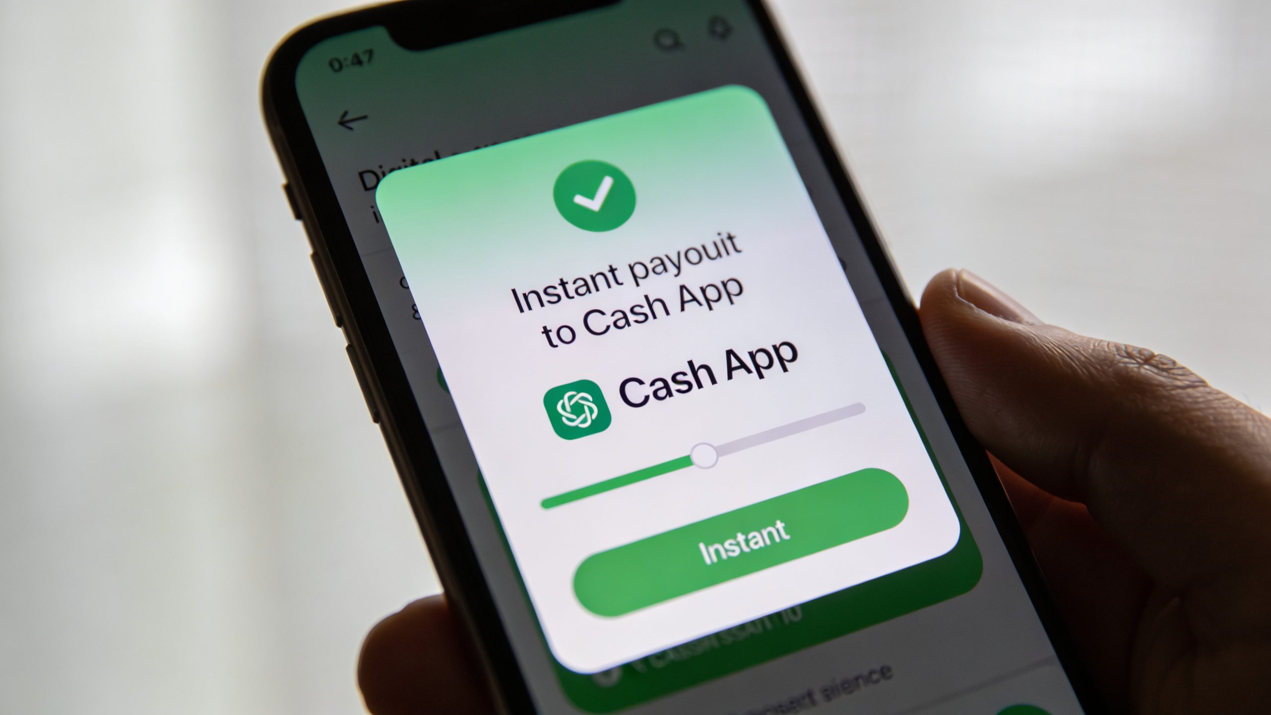 closeup of smartphone screen showing instant payout to Cash App