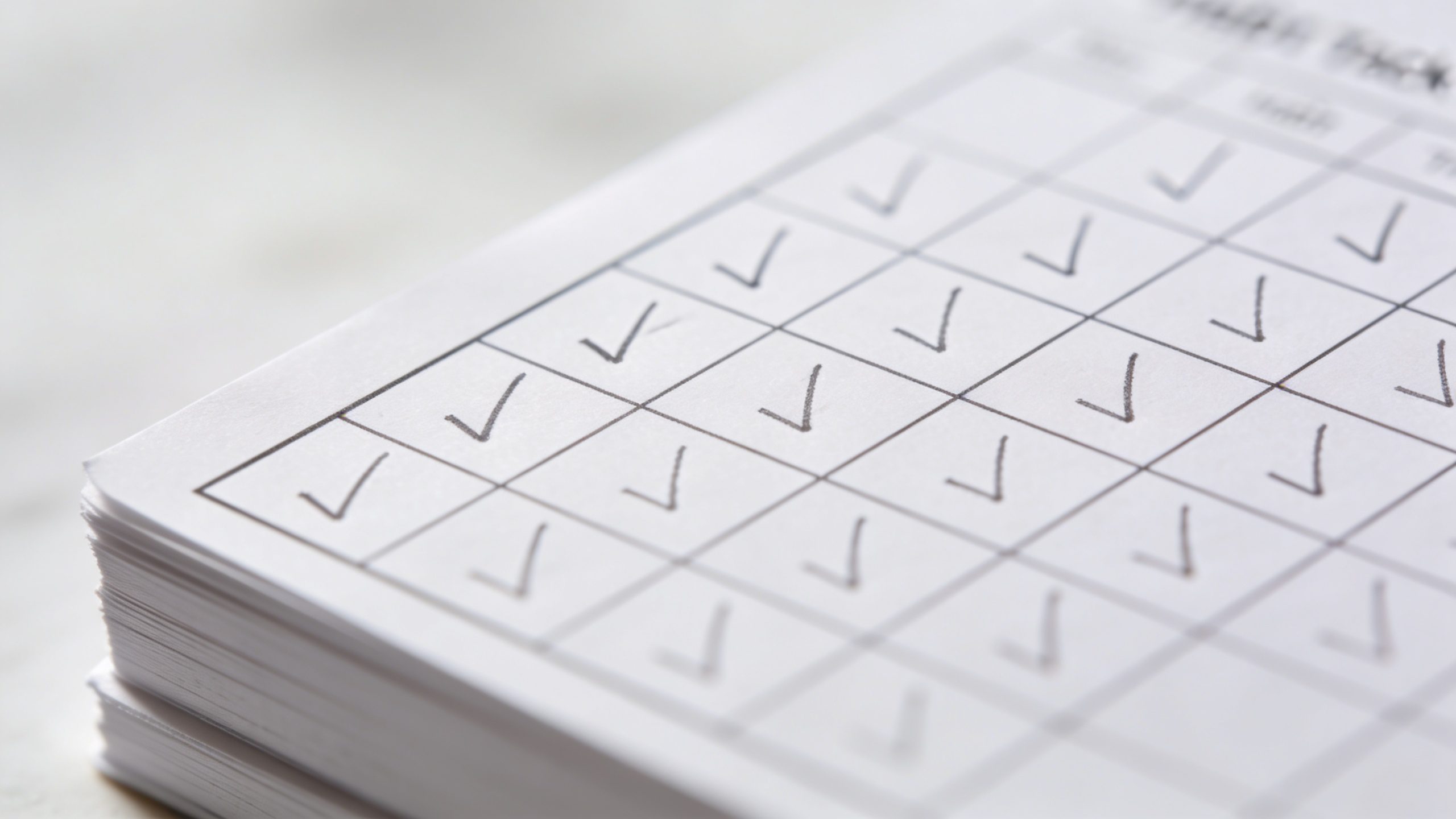 Closeup of a single habit tracker box filled with checkmarks on white paper