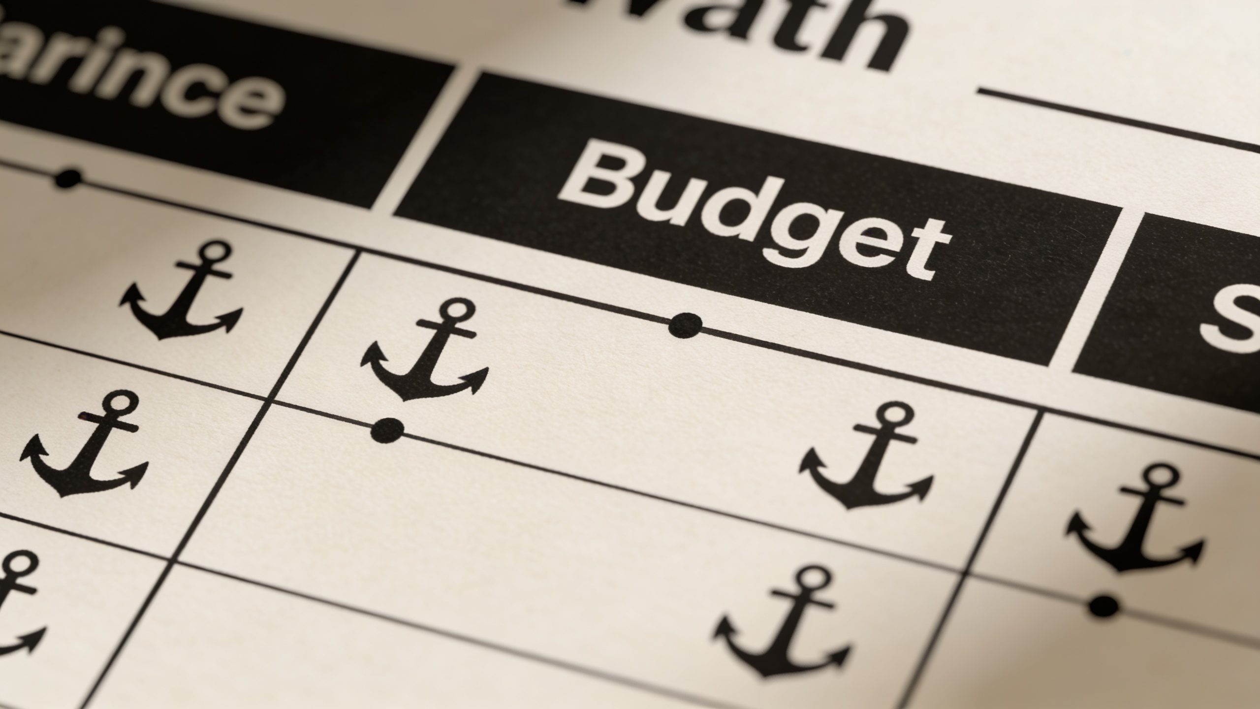 closeup of a minimalist paper budget plan with bold anchors clearly labeled