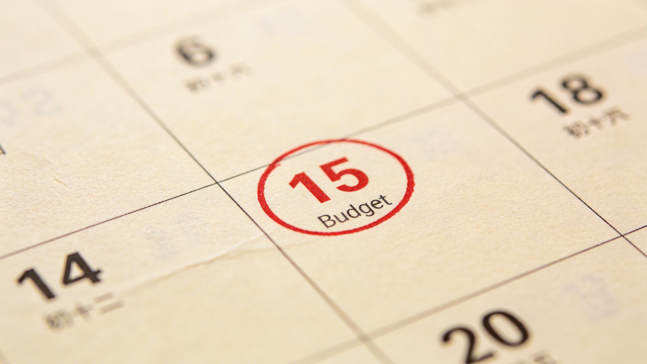 Closeup of a calendar page marking a budget review date
