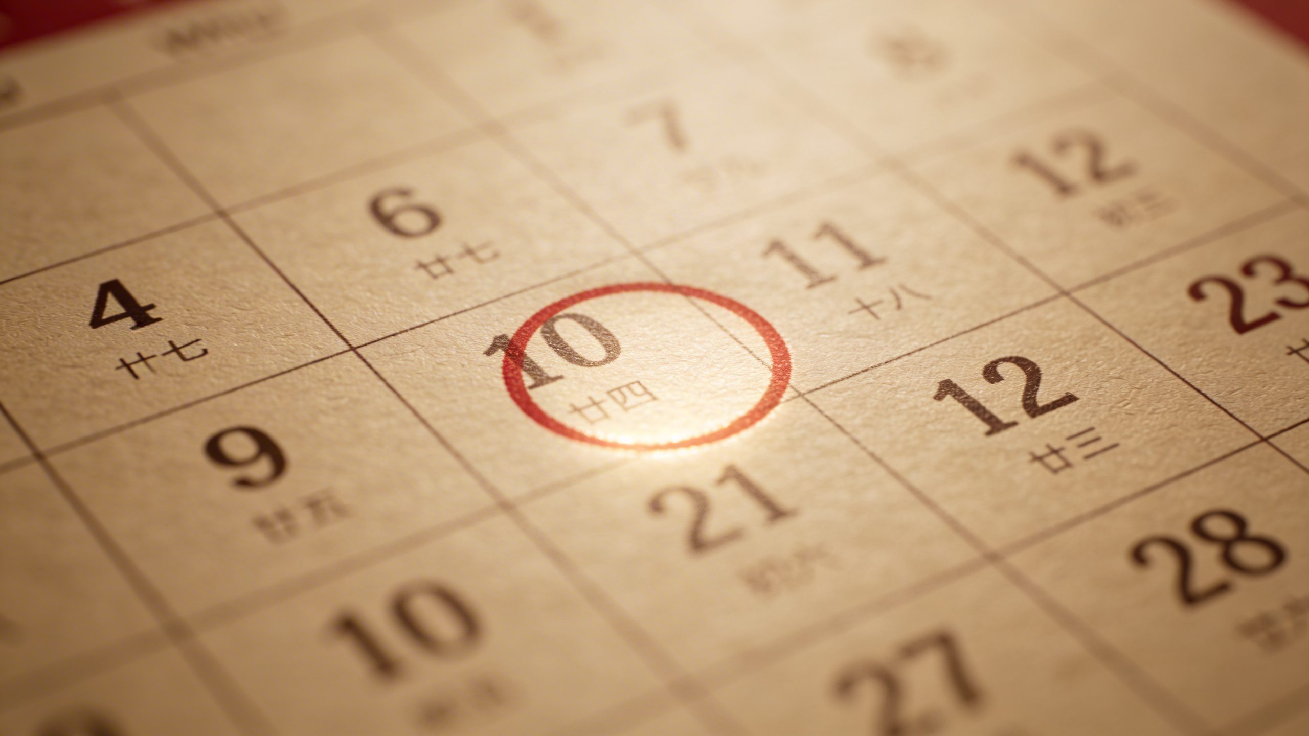 Closeup of a single calendar page marking debt payoff date