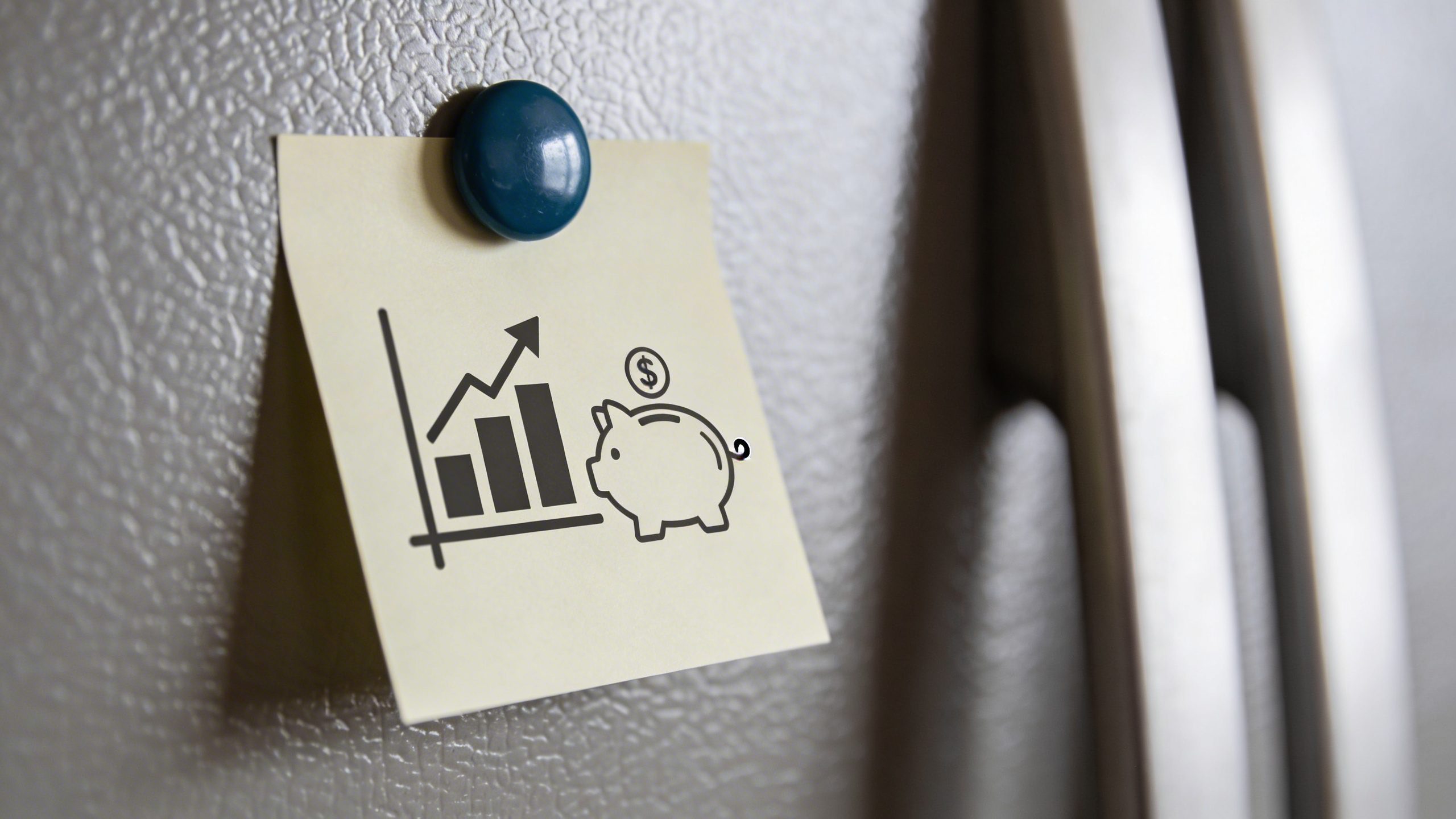 Closeup of a single printed financial goal on a fridge magnet