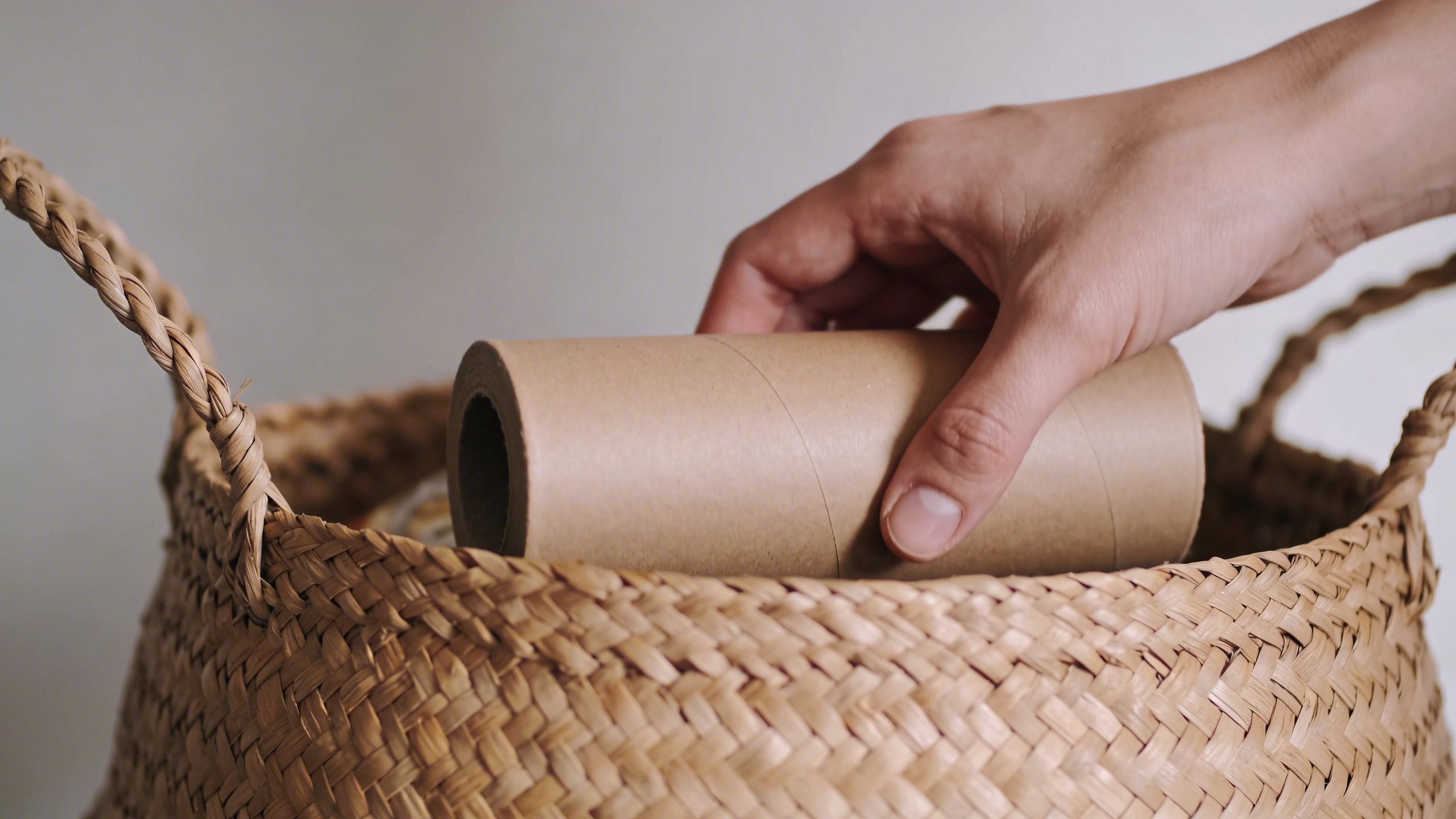 Closeup of a hand placing a generic-brand grocery item in a basket