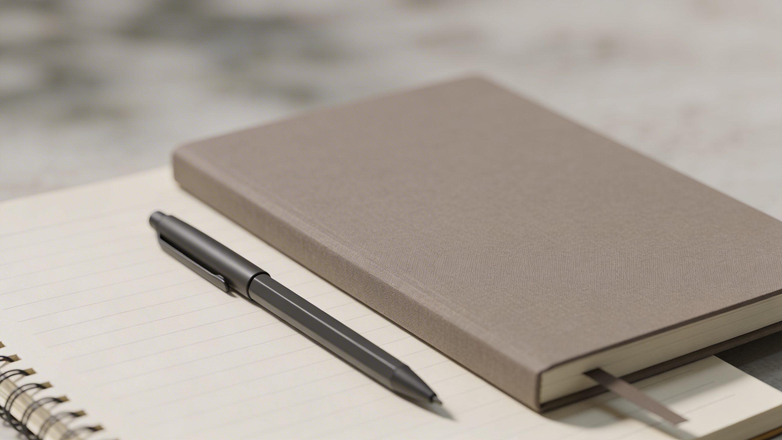 Closeup of a single minimalist budget notebook with a blank page and pen
