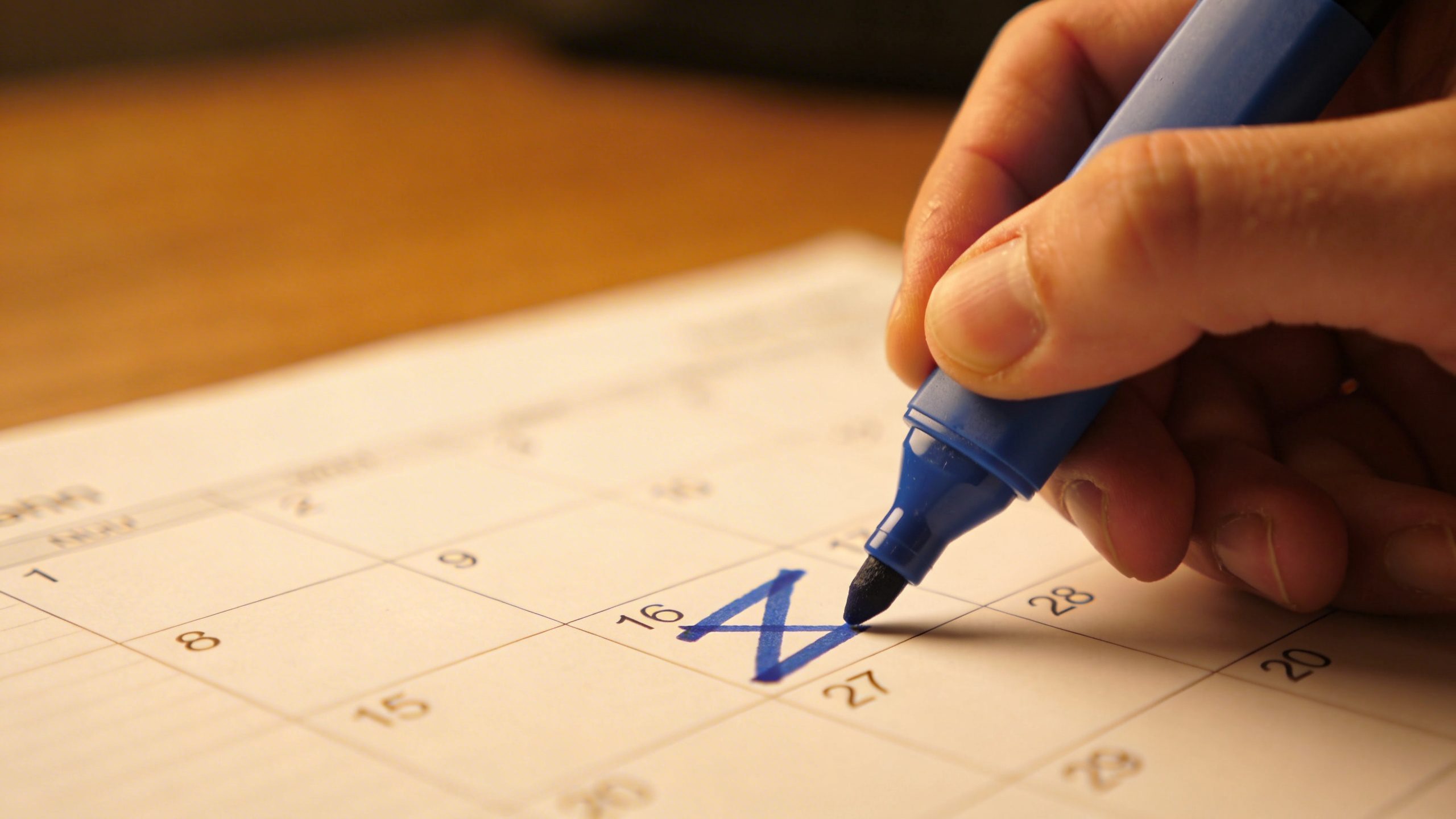 closeup of a person marking peak and lean months on a calendar