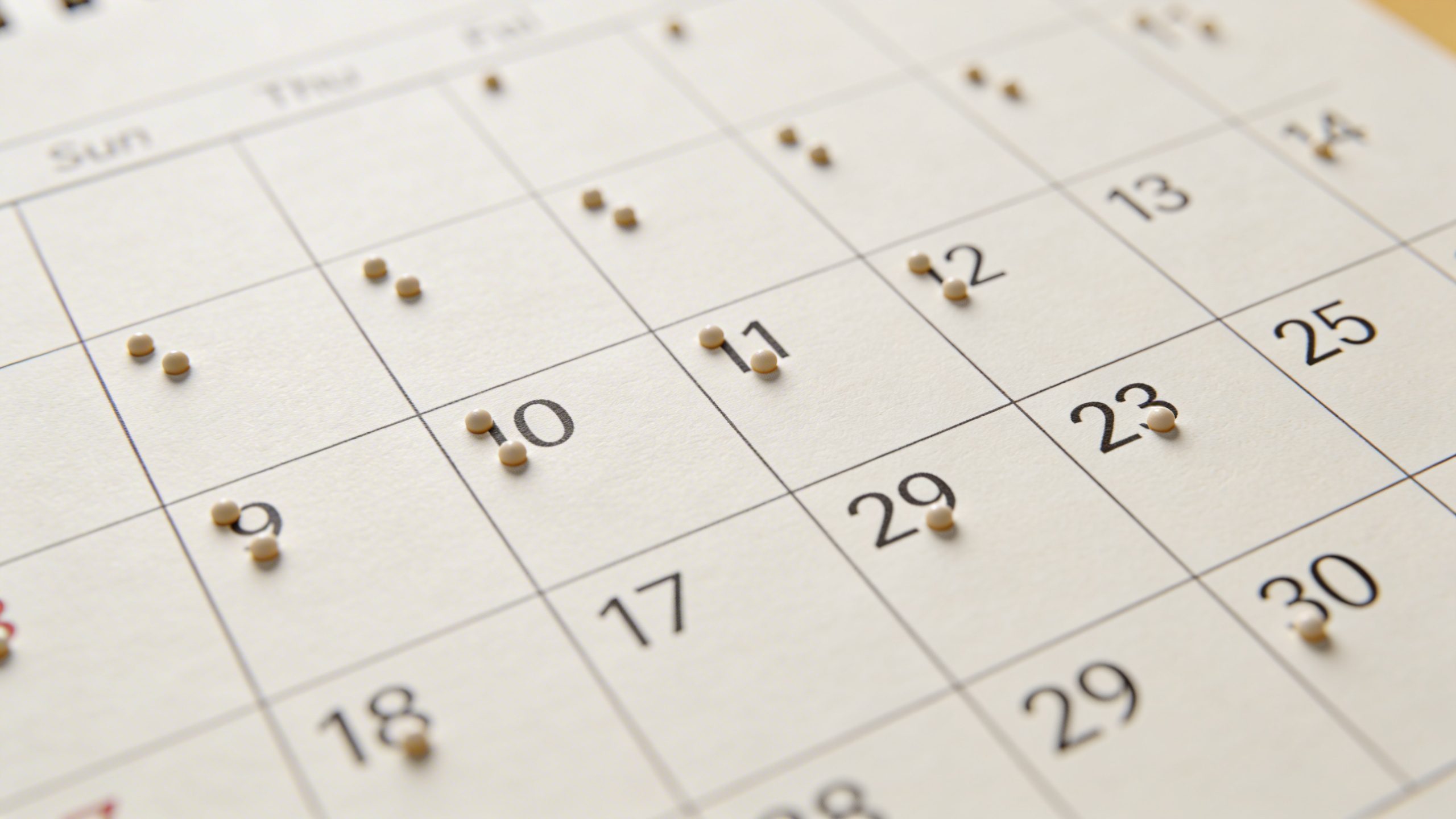 Closeup of a calendar page marking 30-day spending tracking