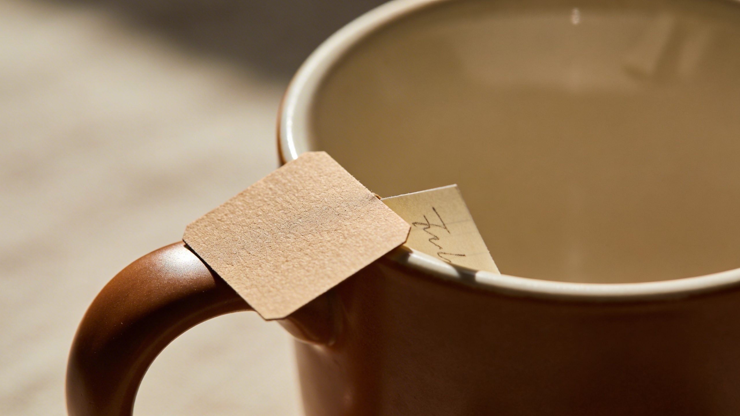 Closeup of a single coffee cup with price tag and tiny handwritten note