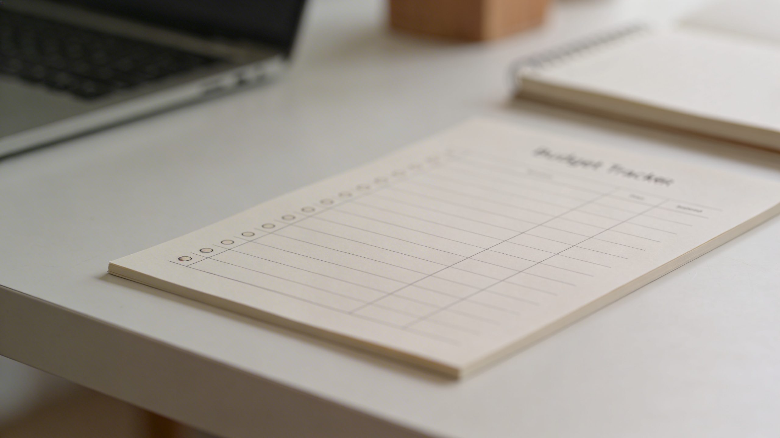 Closeup of a minimalist budget tracker with bullets on a clean desk
