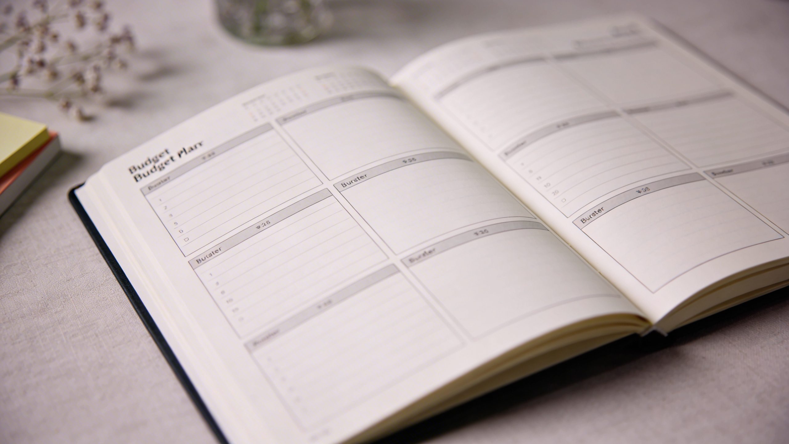 Closeup of a minimalist budget planner opened to a simple template