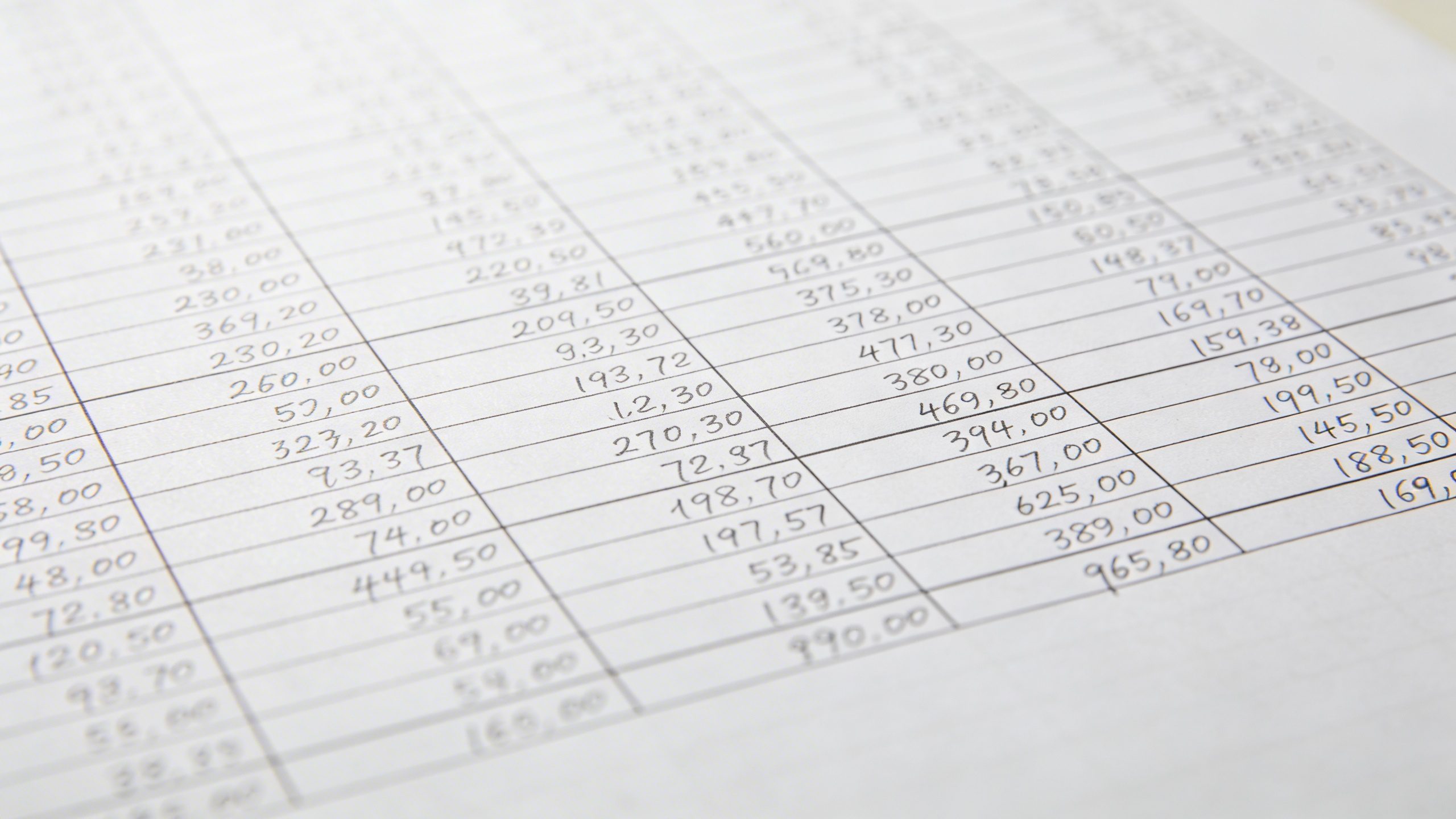 Closeup of a neatly filled monthly expense worksheet on white paper