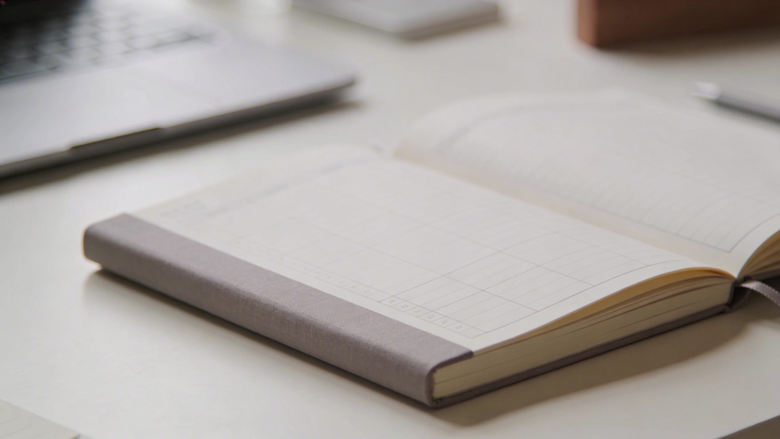 closeup of a simple budget planner journal open on a clean desk