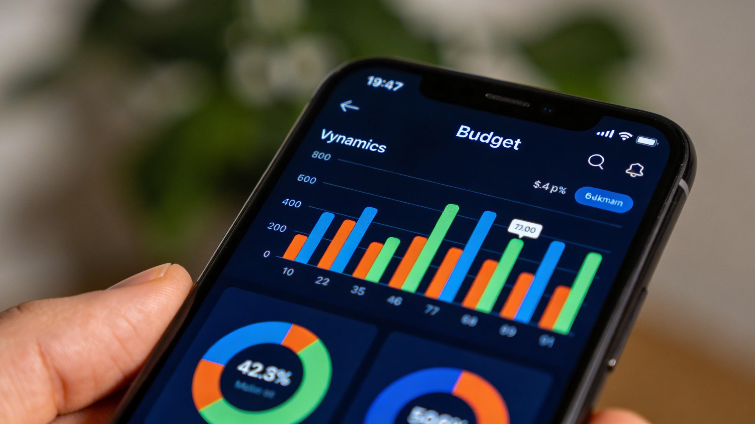 closeup of a smartphone displaying a budget app with vibrant charts