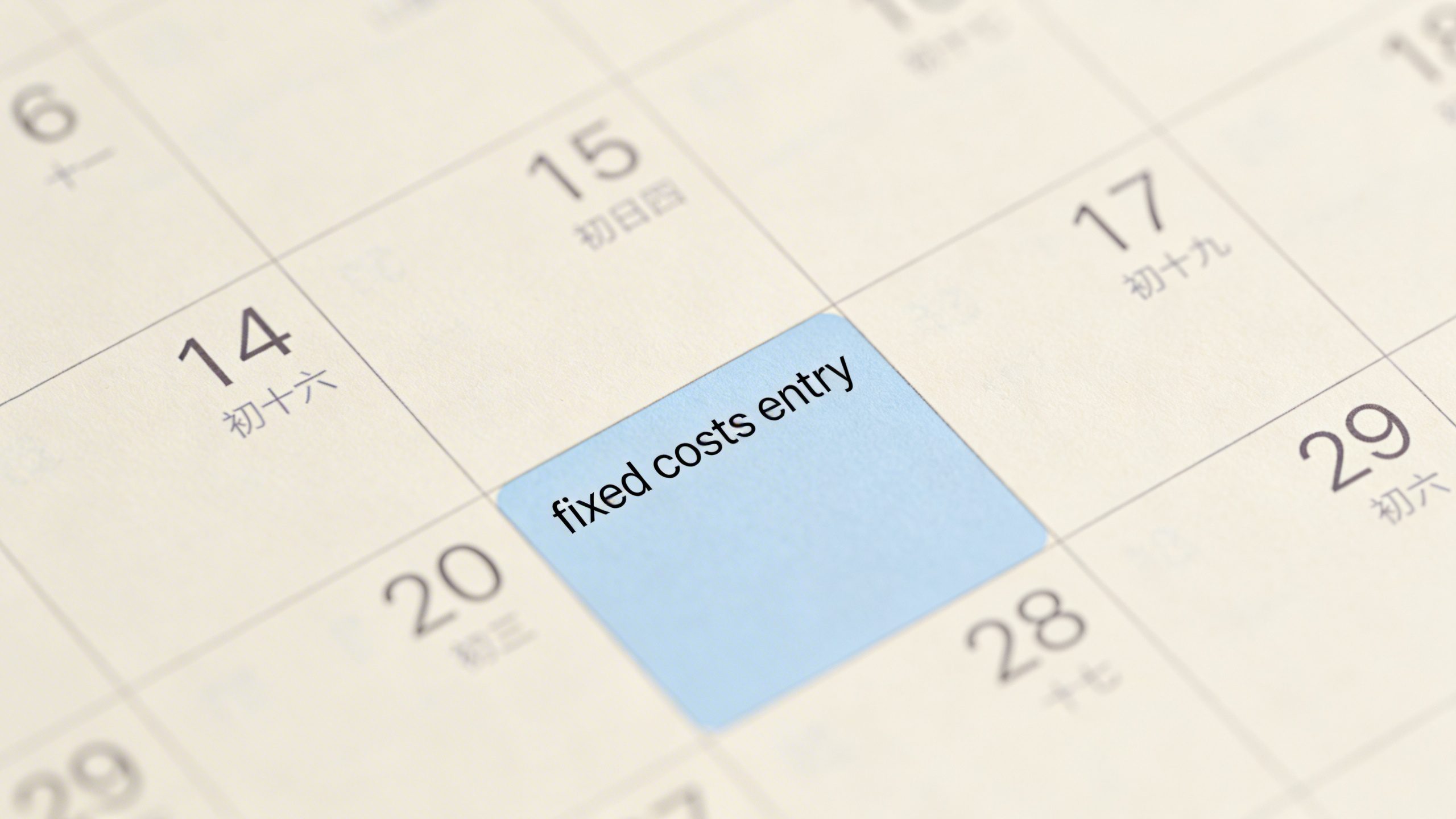 closeup of a single monthly calendar page highlighting fixed costs entry