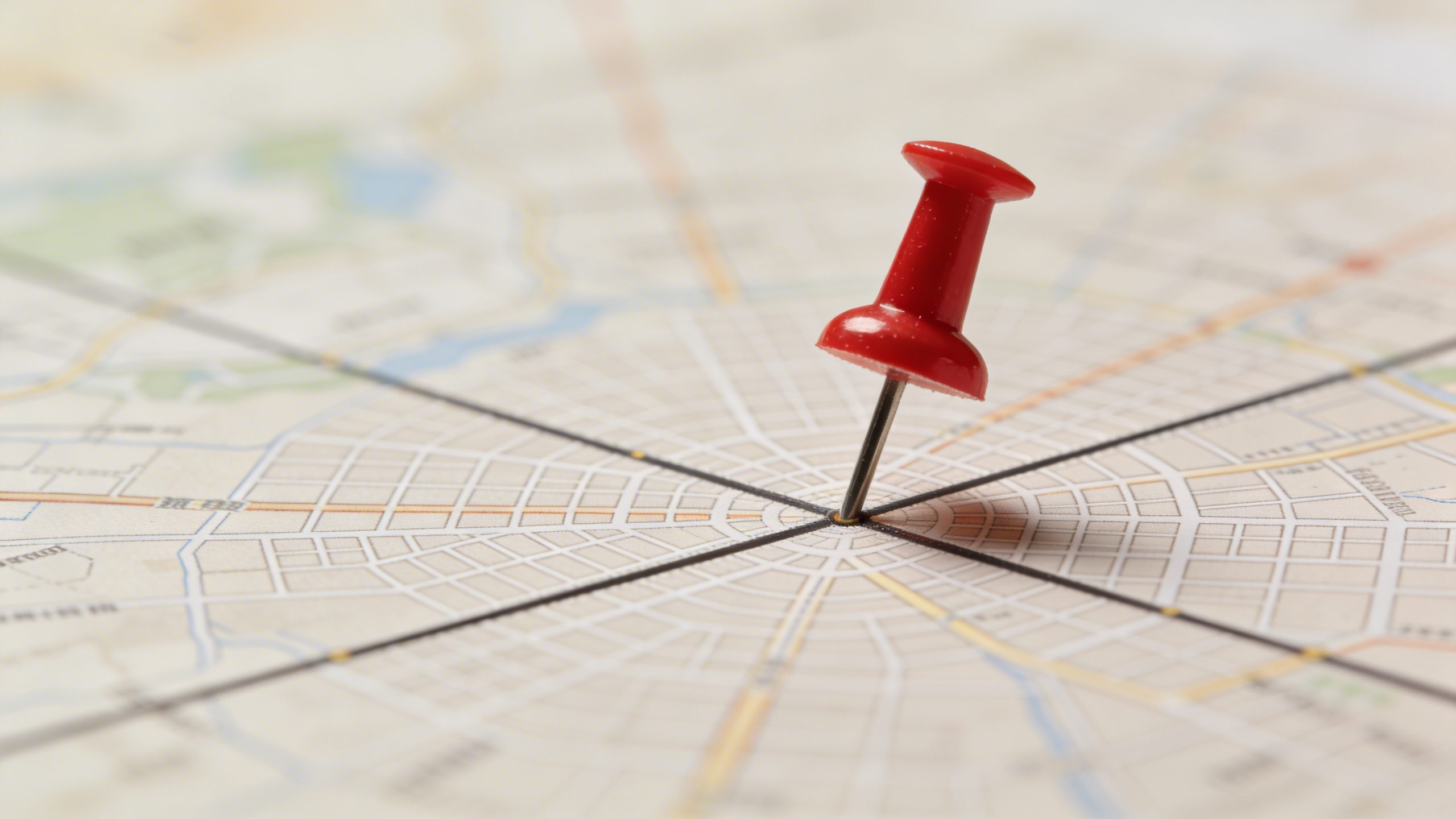 Closeup of a city map with a single red marker pin on budget line