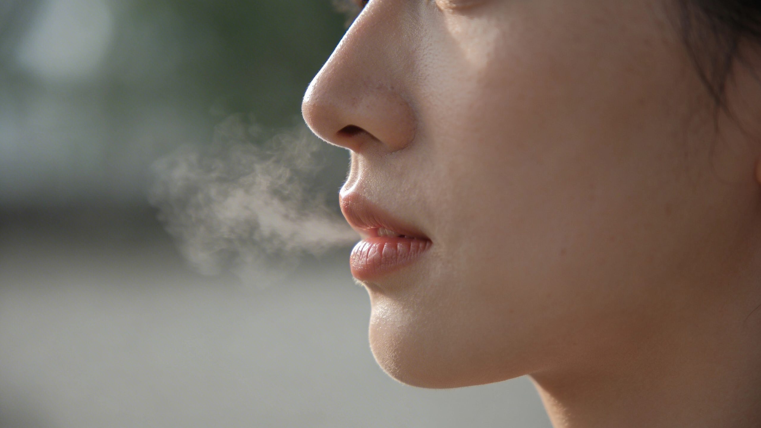 Closeup of a single breath in a calm profile shot with a serene face