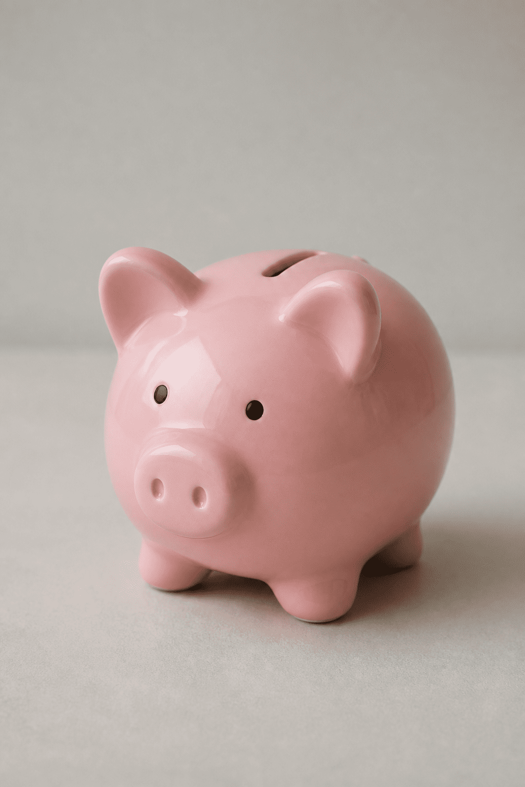 Focused shot of a lone, empty piggy bank on a plain surface