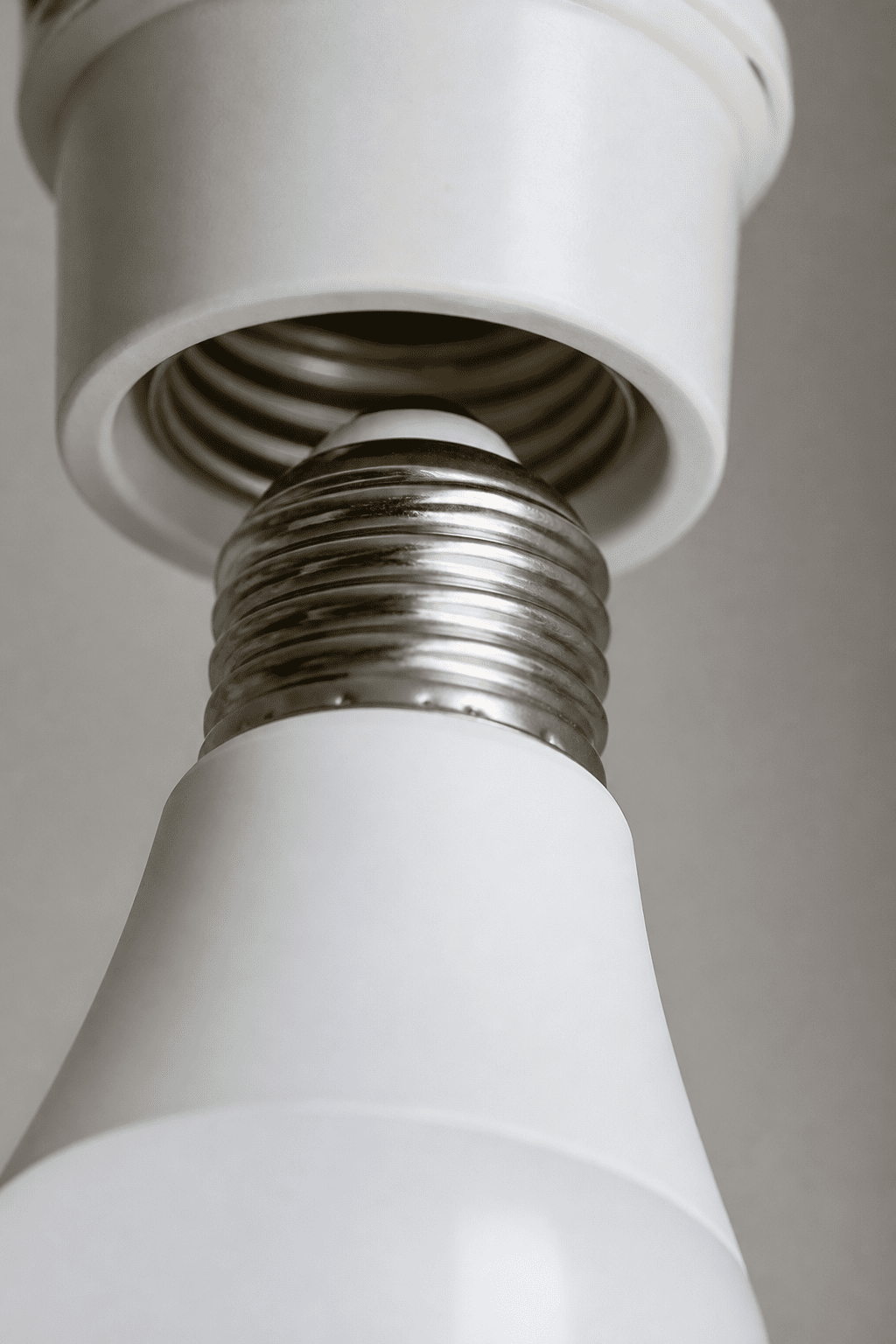closeup of LED light bulb screwing into socket